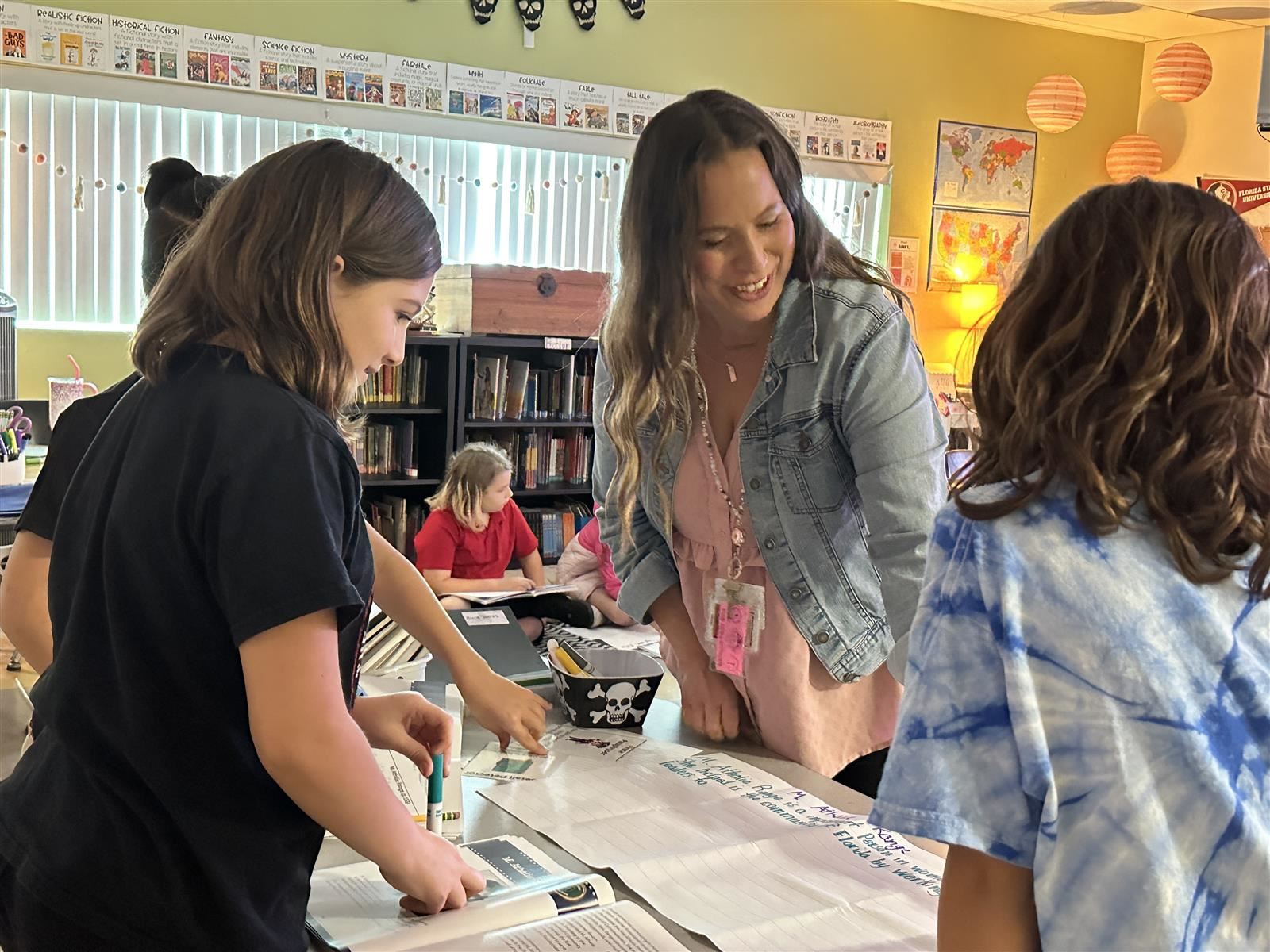 photo of happy teacher working with students