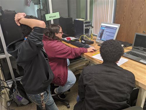 CSIT students working on a computer 