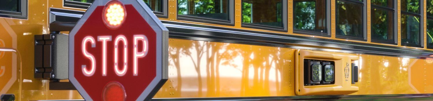 Photo of school bus stop sign and camera on the side of the bus