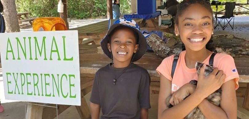 students at Natures Classroom holding an animal