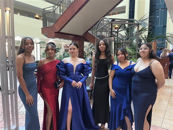 Female cadets wear formal dresses and female guests wear formal gowns or dresses below the knee
